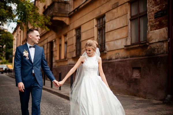 A loving couple of newlyweds walks in the city. Husband and wife on a walk