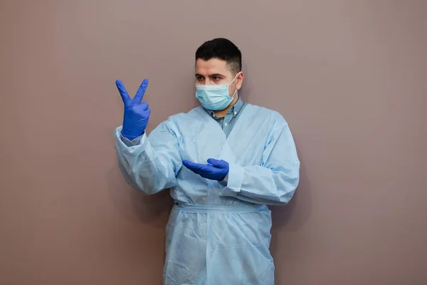 doctor wearing respiratory mask coronavirus epidemic with protective gesture. Healthcare concept