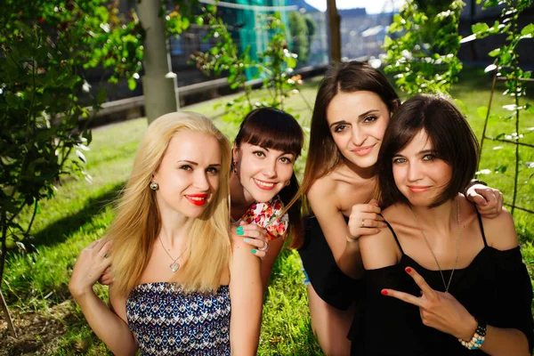 Beautiful four women in the park, happy smiling — Stock Photo, Image