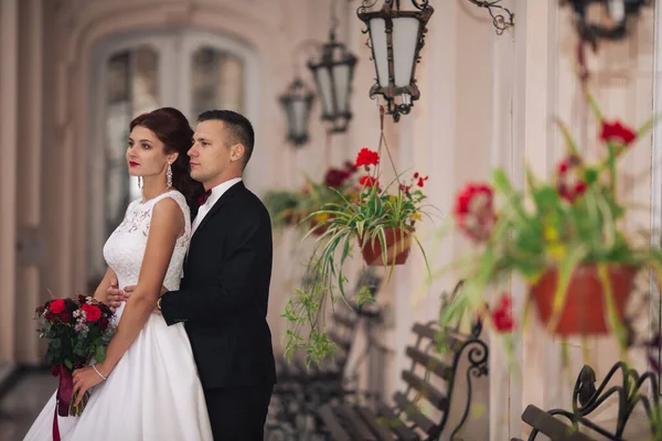 Elegant wedding couple at old vintage house and palace with big wooden stairs.