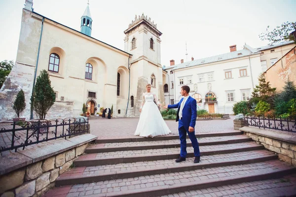 Panna młoda i pan młody spacerują po starym mieście — Zdjęcie stockowe