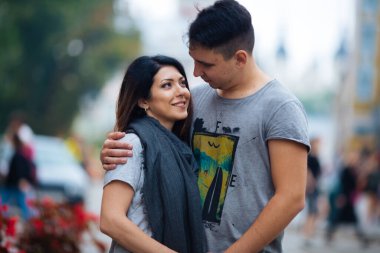 Şehrin arka planında poz veren genç çift, seyahat kavramı