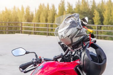 Motosiklet eldivenleri ve emniyet kaskı güvenli olması için spor motosikletinin ön koltuğunda asılı.