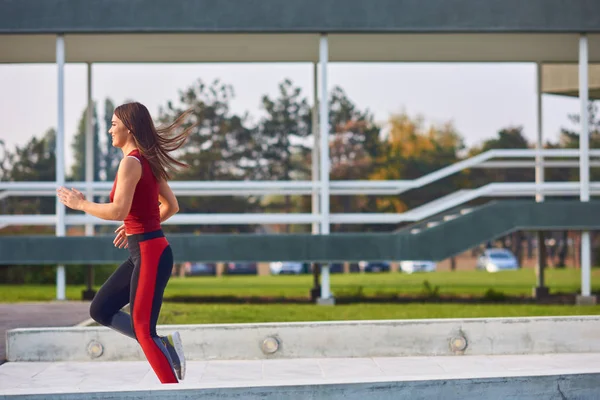 都会の公園で運動・ランニングをする若い女性. — ストック写真