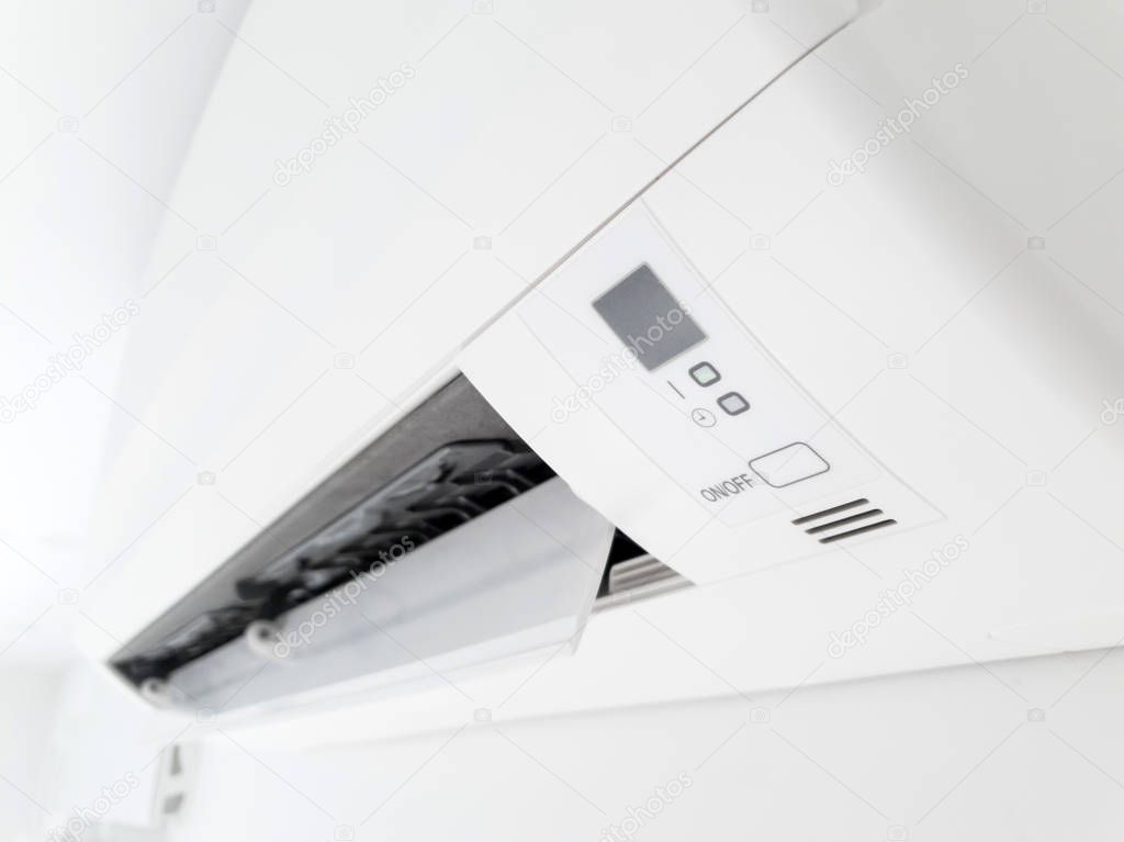 Modern air condition unit on a white wall inside the living room