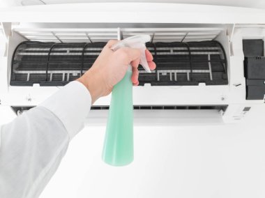 Modern airconditioner unit service cleaning the filter to preven clipart
