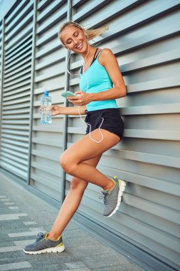 Kentsel alanda koştuktan sonra modern sporcu kadın durakladı.