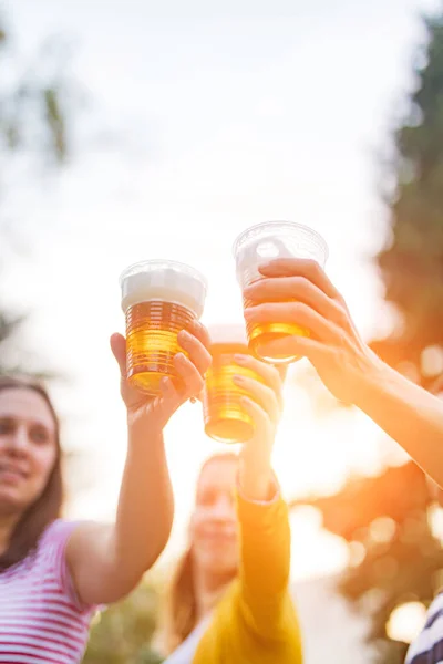 Vrienden genieten van bier drinken in de achtertuin. — Stockfoto