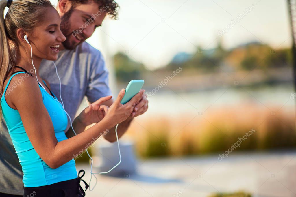 Modern woman and man jogging / exercising in urban surroundings 