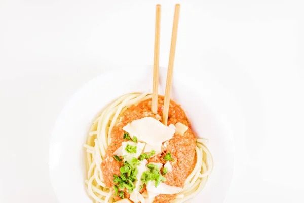 Italian pasta with chopsticks, tomato sauce, parmesan cheese, fr — Stock Photo, Image