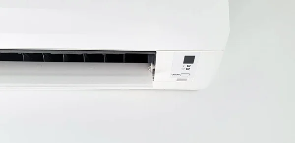 Modern air condition unit on a white wall inside the living room
