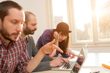 Team made of young architects in the sunny office.