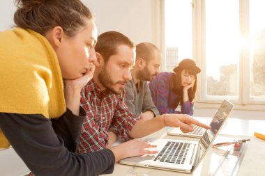 Team made of young architects in the sunny office.
