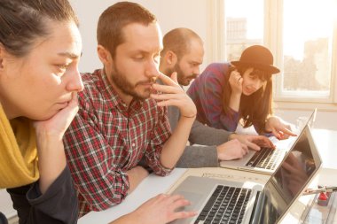 Team made of young architects in the sunny office.