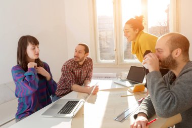 Team made of young architects in the sunny office.
