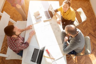 Team made of young architects in the sunny office.