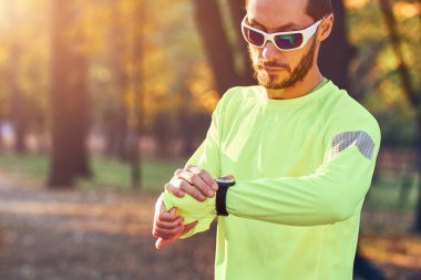 Parkta koşuya / egzersize hazırlanan adam.