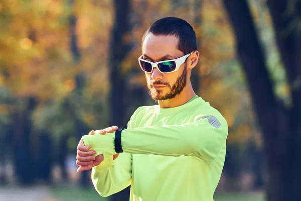 Mężczyzna przygotowujący się do joggingu / ćwiczeń w parku. — Zdjęcie stockowe