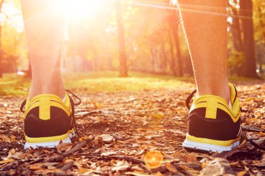 Man with jogging sneakers / shoes in the park.