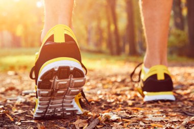 Man with jogging sneakers / shoes in the park.