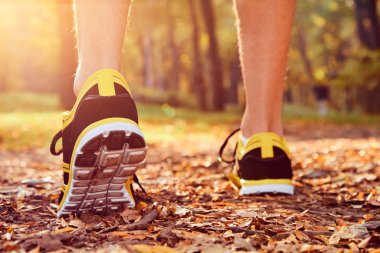 Man with jogging sneakers / shoes in the park.