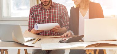 Team made of young architects in the sunny office.