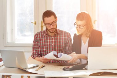 Team made of young architects in the sunny office.