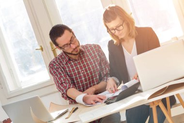 Team made of young architects in the sunny office.