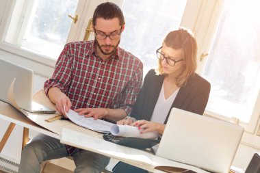 Team made of young architects in the sunny office.