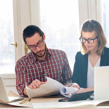 Team made of young architects in the sunny office.