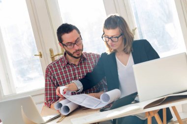 Team made of young architects in the sunny office.