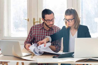 Team made of young architects in the sunny office.