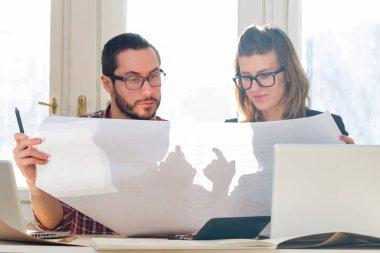 Team made of young architects in the sunny office.