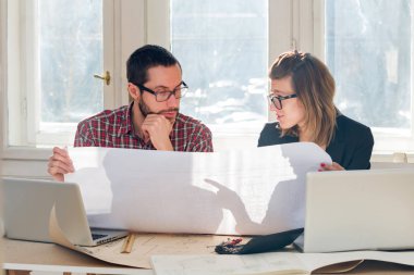 Team made of young architects in the sunny office.