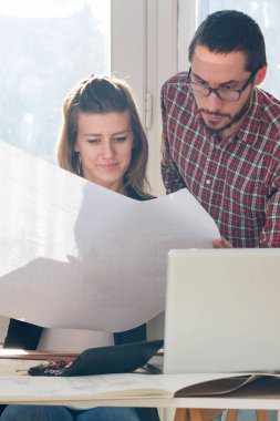 Team made of young architects in the sunny office.