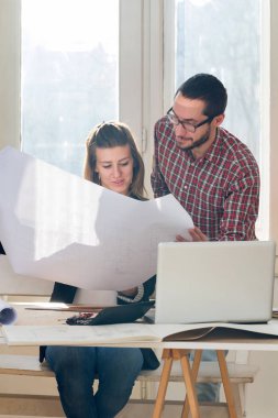 Team made of young architects in the sunny office.