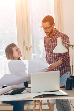 Team made of young architects in the sunny office.