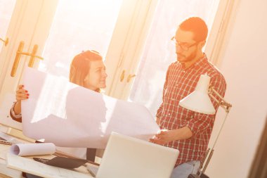 Team made of young architects in the sunny office.