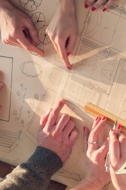 Team made of young architects in the sunny office.