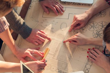 Team made of young architects in the sunny office.