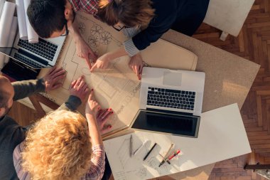 Team made of young architects in the sunny office.