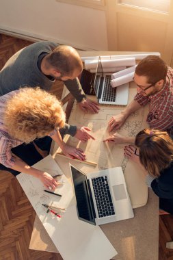 Team made of young architects in the sunny office.
