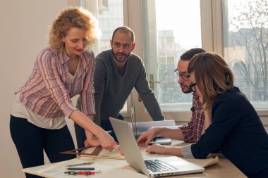Team made of young architects in the sunny office.