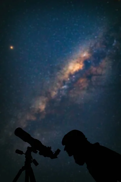 Astronomer with a telescope watching at the stars and Moon. My a