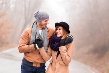 Couple enjoying outdoors in cold autumn / winter time.