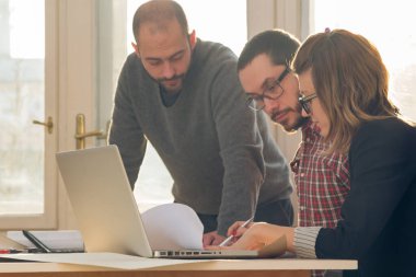 Güneşli ofiste Genç Mimarlar grubu.