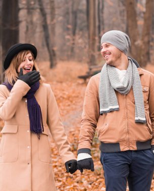 Couple in the park enjoying nice autumn / winter time.