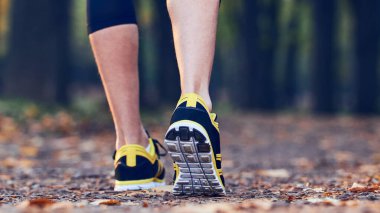 Man with jogging sneakers / shoes in the park.