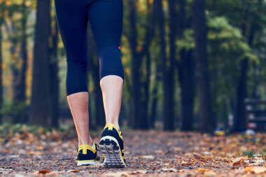 Man with jogging sneakers / shoes in the park.