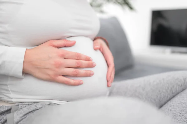 Zwanger vermoeide vermoeide vrouw met maagproblemen thuis op een — Stockfoto